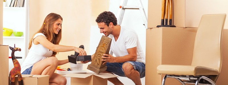 a couple is packing for a move