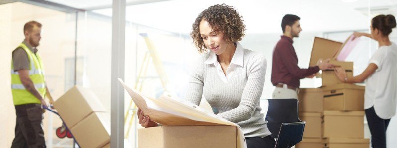group of people packing their office supplies