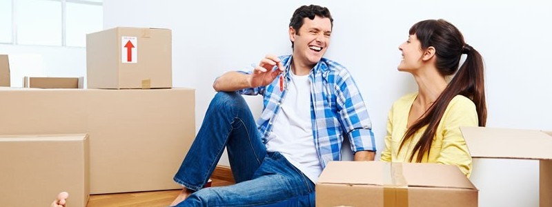 a happy young couple preparing for a house relocation