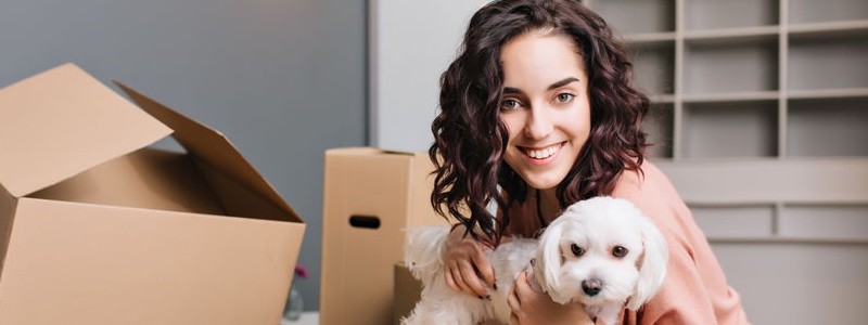 young woman preparing for a house relocation with her dog