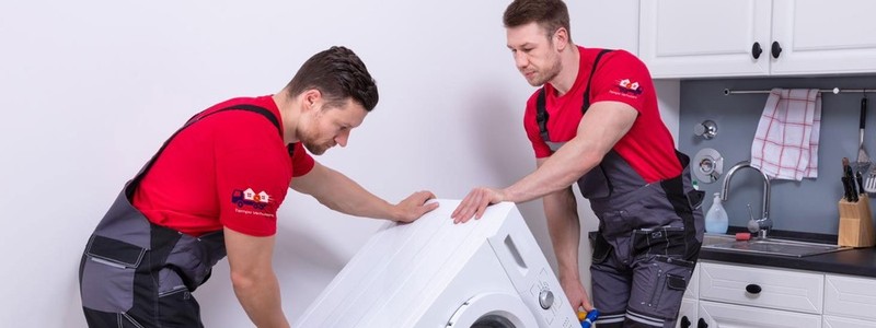 professionals trying to relocate a washing machine