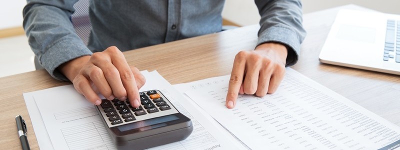 cropped picture of a person calculating something on a calculator