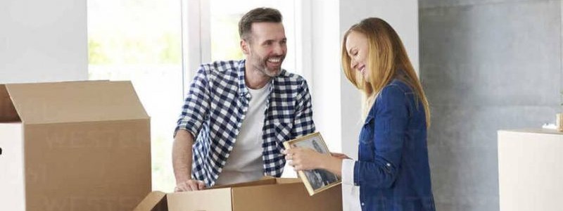 young couple unpacking household items