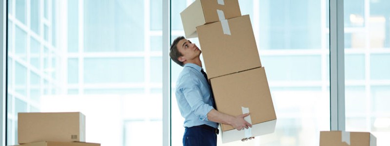 young man holding some cardboard boxes in hand