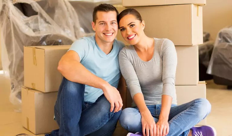 couple sitting on the floor inside of their new house