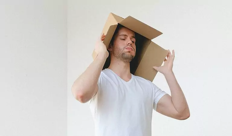 young man holding a box on his head
