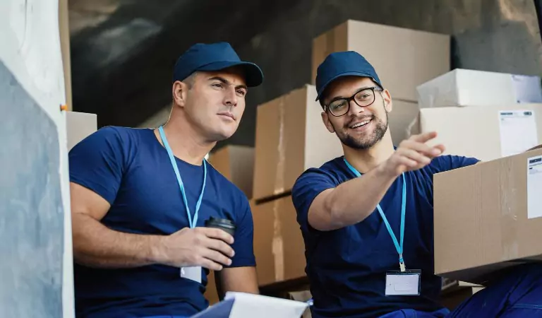 young professionals unloading a truck full of boxes