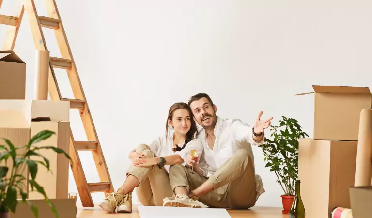 couple sitting on the floor with their household