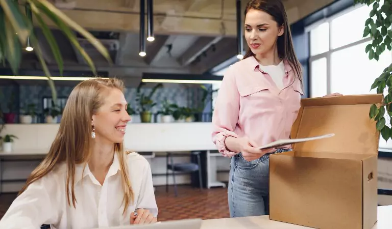 women packing up an office