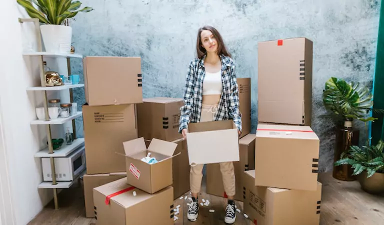 young woman holding a cardboard box