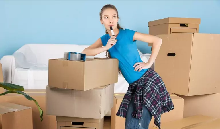 woman with some boxes inside of a house