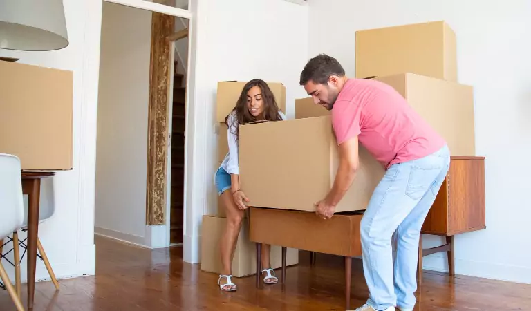 couple trying to move heavy household items