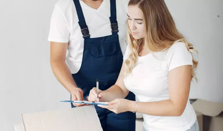 woman signing a contract with a professional