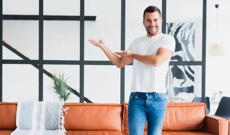 young man inside of a house pointing on something
