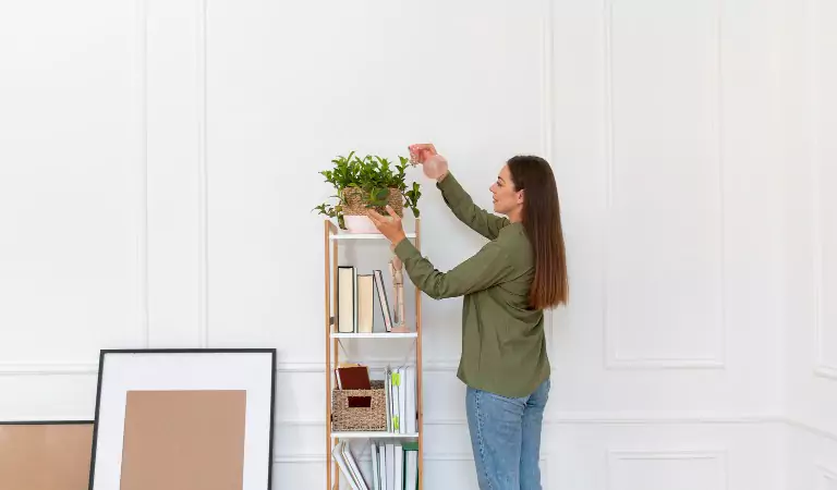 Young woman decorating her house after moving in