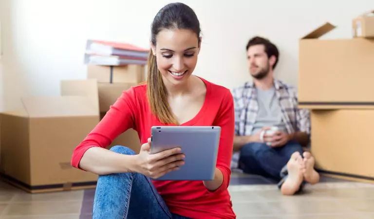 couple inside of a house with some cardboard boxes