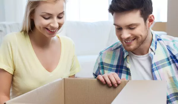 couple unpacking a cardboard box
