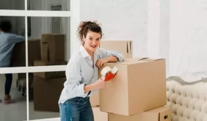woman with some cardboard boxes inside of a house