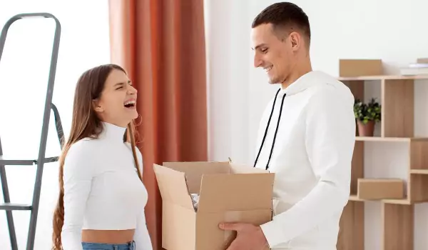 couple inside of a house with some boxes